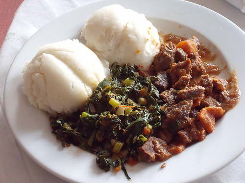 Beef seswaa, bogobe (pap), and morogo. A delicious local meal served in Botswana. 